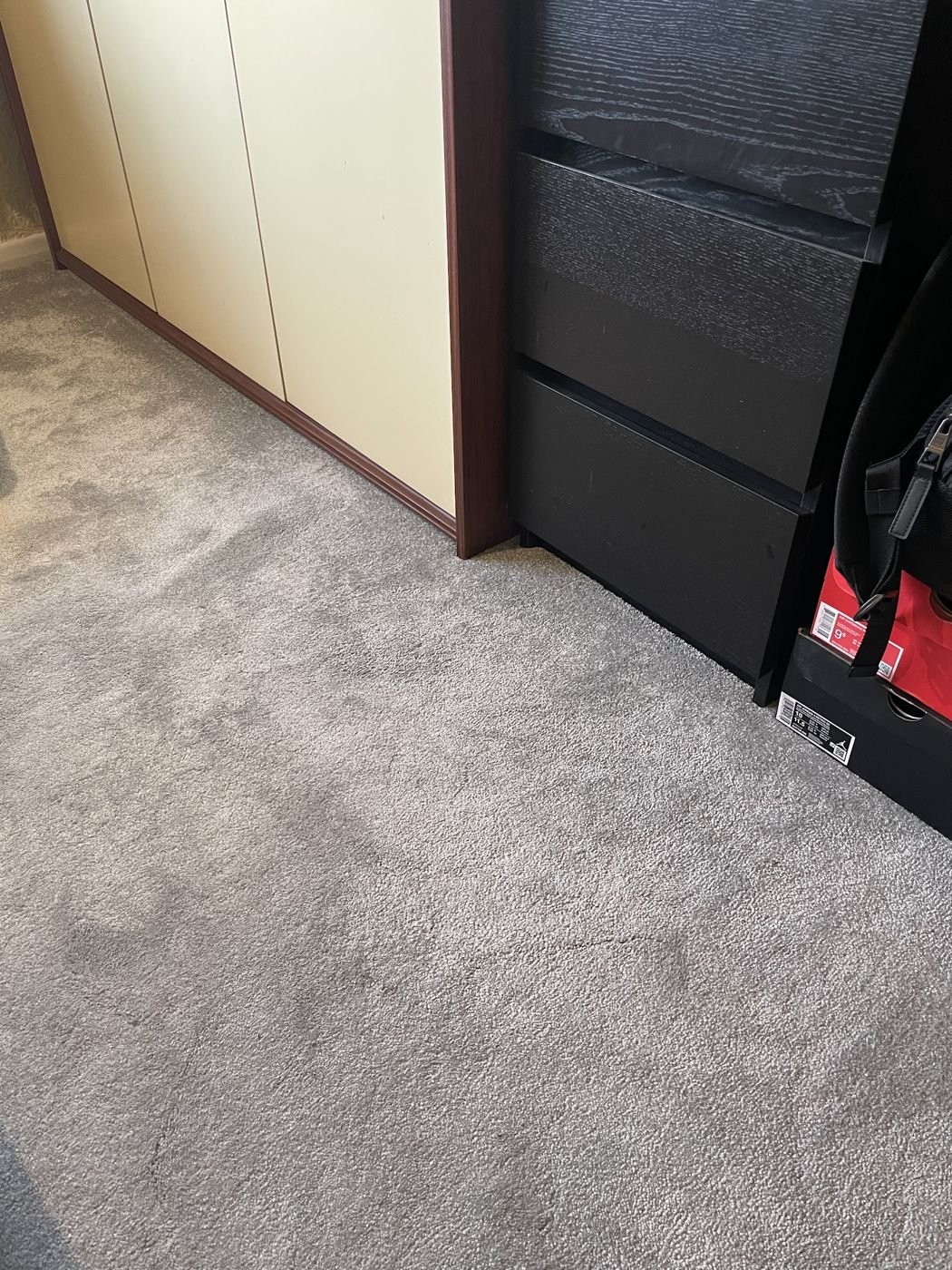 Grey carpet fitted beside a wardrobe