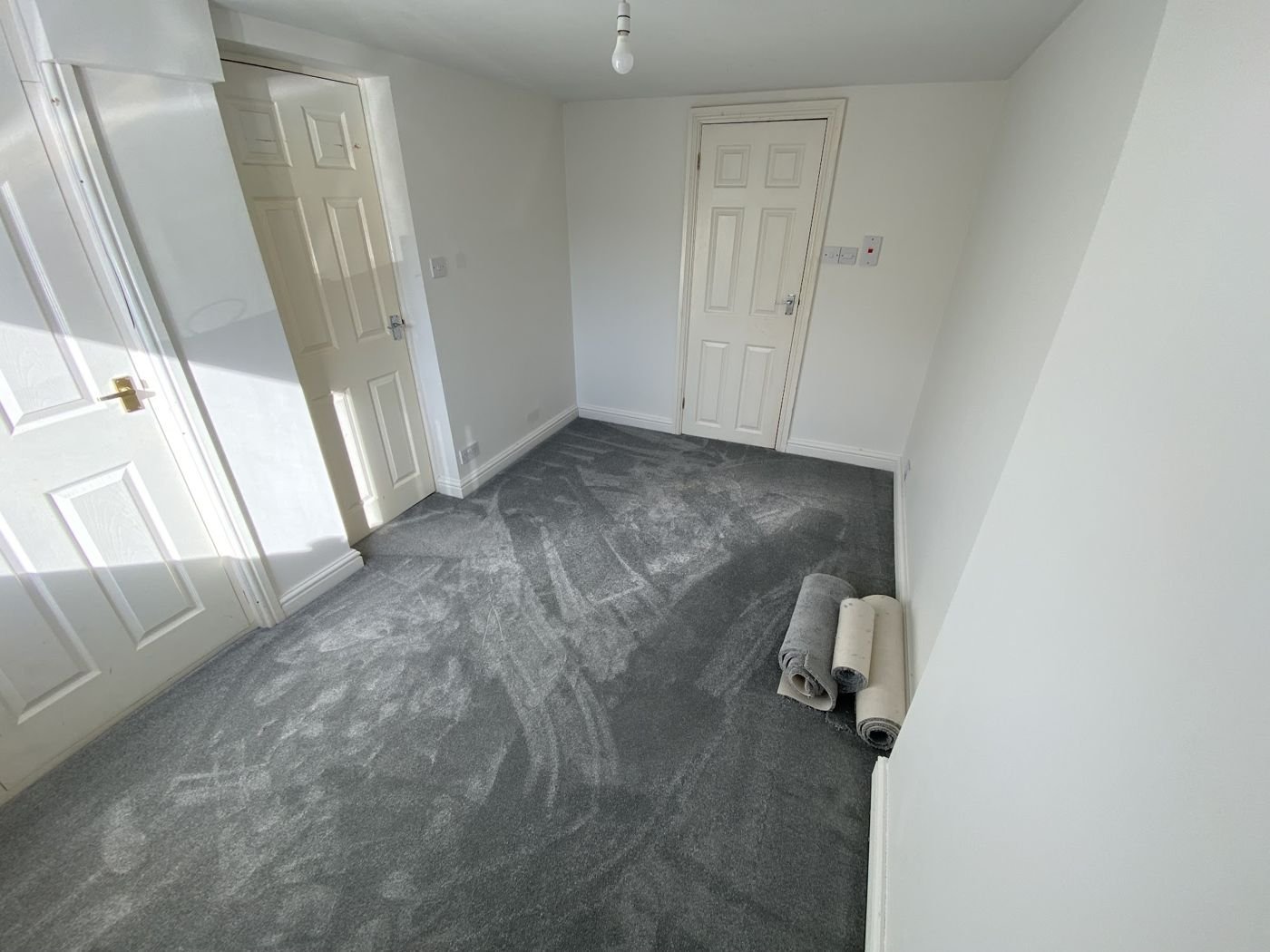 A carpet roll left in a newly fitted bedroom