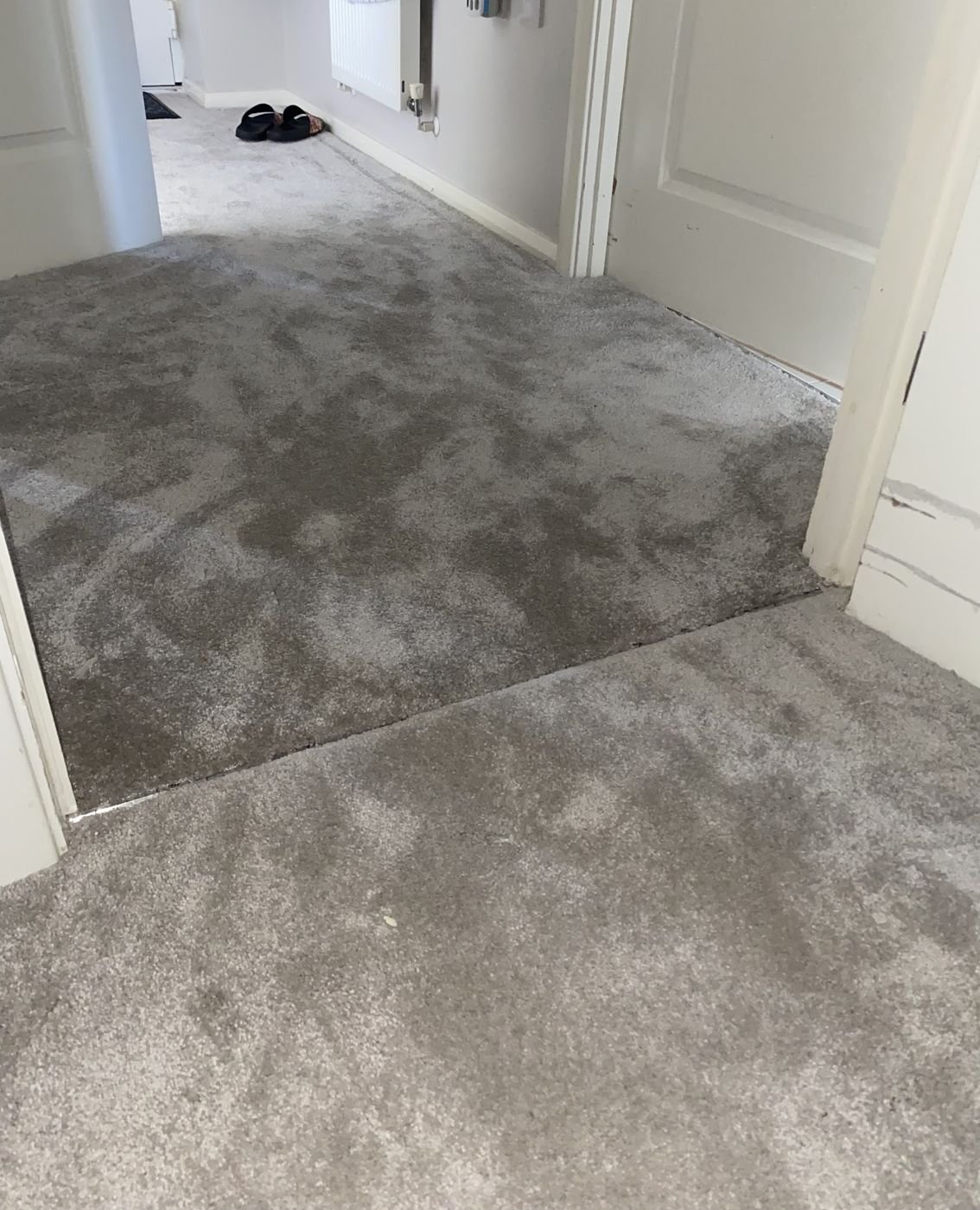 Grey carpet fitted across a doorway threshold
